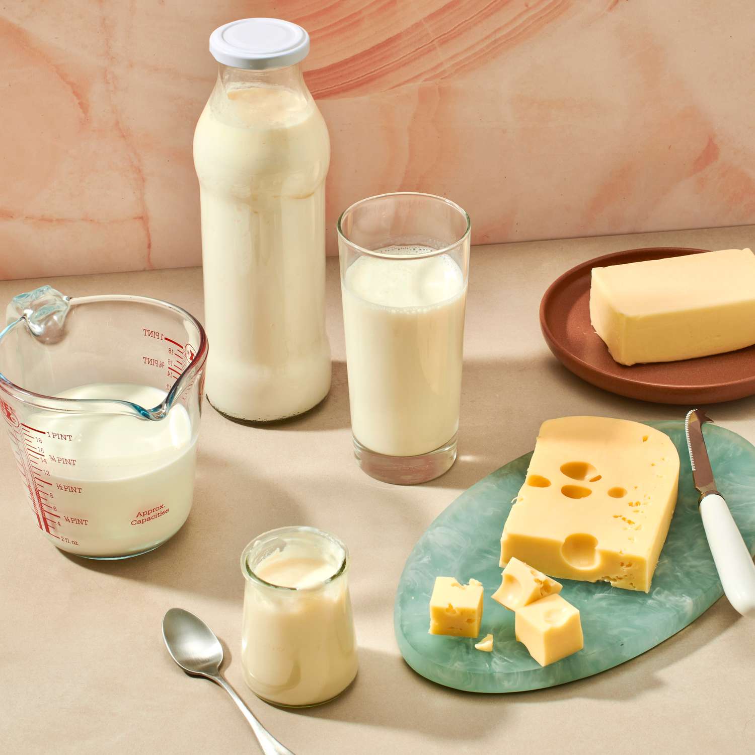 Assorted dairy products including milk, butter, yogurt, and cheese displayed on a table